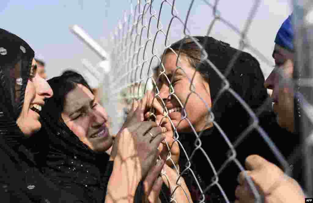 Newly displaced Iraqi's who fled from the city of Mosul, Iraq's last major Islamic State (IS) group stronghold, are reunited with their relatives who came two years ago to the refugee camp in the Khazer area, near the Kurdish checkpoint of Aksi Kalak some 40 kilometers east of Irbil.