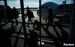 Passengers make their way through the terminal as they travel ahead of the Thanksgiving holiday at Washington Dulles International Airport in Dulles, Virginia, Nov. 22, 2023.