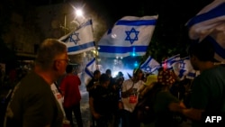 Israeli police use water canon to disperse protestors near the residence of the Israeli prime minister during an anti-government rally calling for early elections, in Jerusalem on June 17, 2024.