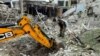 A police bomb squad member works at the site of a Russian airstrike in Kharkiv amid Russia's attacks on Ukraine, June 23, 2024. 