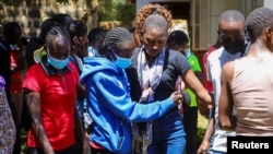 People react after viewing the body of Kelvin Kiptum at the Racecourse Mortuary, in the Rift Valley town of Eldoret, Kenya, Feb. 12, 2024.