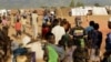 FILE - Refugees wait for registration at Kapise camp in Malawi's Mwanza district, Jan. 18, 2016. 