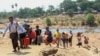 People cross the Moei river as they flee Myawaddy township in Myanmar to Thailand's Mae Sot town in Thailand's Tak province, April 20, 2024. 