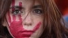 Seorang perempuan mengikuti unjuk rasa untuk memperingati Hari Penghapusan Kekerasan Terhadap Perempuan, di Milan, Italia, Sabtu, 25 November 2023. (Foto: Luca Bruno/AP Photo)