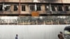 People walk outside a shopping mall that was burnt during the demonstration against Kenya's proposed finance bill, in Nairobi, Kenya, June 28, 2024. 