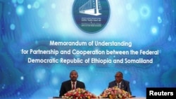 FILE - Somaliland President Muse Bihi Abdi, right, and Ethiopia’s Prime Minister Abiy Ahmed attend the signing of the Memorandum of Understanding agreement that allows Ethiopia to use a Somaliland port, in Addis Ababa, Ethiopia, Jan. 1, 2024. 