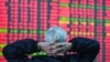 An investor looks at a screen showing stock market movements at a securities company in Hangzhou, in eastern China's Zhejiang province on Feb. 8, 2024. 