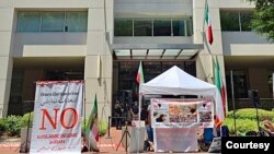 Iranian American activists from the National Solidarity Group for Iran protest outside Iran's interests section office in Washington on July 5, 2024, denouncing its use as a ballot station for the runoff vote of Iran's presidential election. (Courtesy of NSGIran)