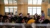 Grade 12 students use hand fans as they attend a class at the Commonwealth High School in Quezon City, Metro Manila, Philippines, April 18, 2024. 