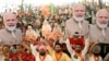 Supporters of the ruling Bharatiya Janta Party (BJP) hold cutouts of India's Prime Minister and their leader, Narendra Modi, as they shout slogans during an election campaign rally in Amritsar on May 30, 2024.