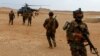 FILE - Iraqi Special Forces members board a helicopter during the "Solid Will" military operation against Islamic State militants in the desert of Anbar, Iraq, April 23, 2022. 