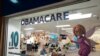 FILE - An insurance agent talks with clients inside the main location of Las Madrinas de los Seguros, Spanish for "The Godmothers of Insurance," at a shopping center in Miami, on Dec. 5, 2023. 