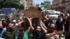 Syrians attend the funeral procession of a man killed during clashes with Turkish troops, in Afrin in northern Syria on July 2, 2024.