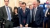 U.S. Representatives — from left, Jake Auchincloss, Haley Stevens, Mike Gallagher, and Carlos Gimenez — gather for a tabletop war game exercise April 19, 2023, in Washington. The lawmakers serve on a new House select committee on China. Mike Gallagher serves as chair.