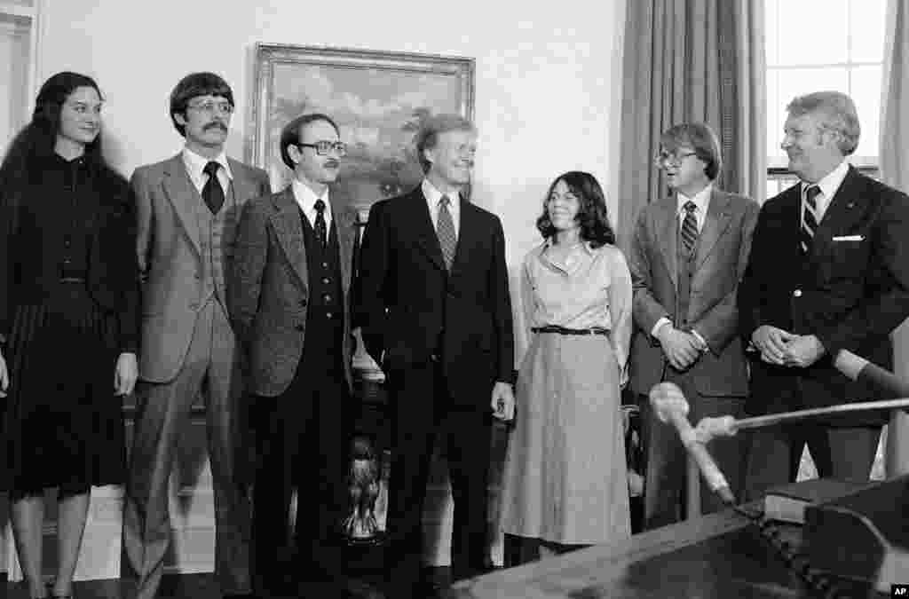 Six Americans who escaped from Iran with the help of the Canadian government meet with President Jimmy Carter in the Oval Office in Washington, Feb. 1, 1980.