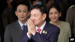 Thailand's former Prime Minister Thaksin Shinawatra, center, with his son Phantongtae and his daughter Pinthongta, arrives at Don Muang airport in Bangkok, Thailand, Aug. 22, 2023.