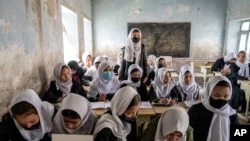 FILE - Afghan school girls in class on the first day of the new school year in Kabul, March 25, 2023. Though Afghanistan's new school year had started, high schools remained closed to girls for the second year since the Taliban returned to power.