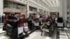 People sit near their luggage at the Beirut–Rafic Hariri International Airport, in Beirut, Lebanon, July 29, 2024.