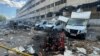 A firefighter works at a site of a branch of courier service Nova Poshta, hit by a Russian airstrike, amid Russia's attacks on Ukraine, in Kharkiv, northeastern Ukraine, June 30, 2024.