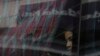 FILE - A migrant looks out the window on a bus on her way north to Nicaragua and hopefully to the Mexico-United States border, in Paso Canoas, Costa Rica, Oct. 16, 2023.