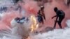 FILE - A tear gas canister explodes in downtown Nairobi as protesters try to help injured people outside the Kenya Parliament during a strike to protest tax hikes and the 2024 finance bill. After the protests, Kenya experienced a nationwide loss in internet connectivity. 