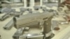 Handguns are displayed in a shop window in central Bangkok.