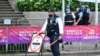 FILE - Police guard a checkpoint in the Wanchai district of Hong Kong on June 30, 2022. A top Chinese official said March 6, 2023, that Hong Kong must nip in the bud any potential threats to national security.