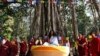 FILE - Ram Bahadur Bamjan, center in white, is surrounded by Buddhist monks in Nijgadh town, south of Katmandu, Nepal, Nov. 12, 2008. 