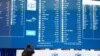 A man takes a photograph of the election results at the National Results Operation Centre of the IEC in Midrand, South Africa, June 2, 2024. 