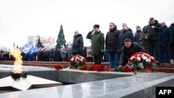 FILE - Mourners gather to lay flowers in memory of more than 60 Russian soldiers that Russia says were killed in a Ukrainian strike on Russian-controlled territory, in Samara, on Jan. 3, 2023. 