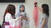 FILE - Manga-inspired cosplay fans attend a comics expo in Shanghai, China, July 11, 2013. China is circulating a draft version of a law to police clothing "hurtful" to the country's spirit, possibly including Japan-inspired costumes.