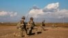 FILE - U.S. soldiers pause during a patrol in Syria, Feb. 3, 2023.