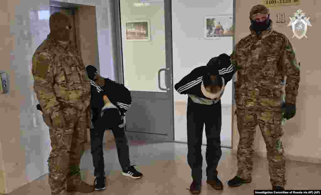 In this photo taken from video released by Investigative Committee of Russia on March 24, 2024, suspects in the Crocus City Hall shooting on Friday are escorted inside the Russian Investigative Committee headquarters in Moscow, Russia.