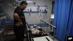 Palestinian children wounded in Israeli strikes wait for treatment in Shifa Hospital in Gaza City, Oct. 13, 2023.