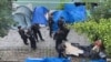 Rights groups criticize efforts to displace migrants ahead of Paris Olympics
