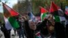 FILE - A woman waves flags in support of Palestinians in Gaza during a protest in Istanbul, April 5, 2024. Turkey and Israel announced tit-for-tat trade barriers, April 9.