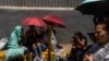 Hundreds of people from poor neighborhoods wait in front of a detention center in Caracas, Venezuela, looking for information about their relatives who were arrested during the protests against the election results, on Aug. 1, 2024. 