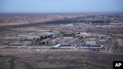 FILE — This Dec. 29, 2019, aerial photo shows Iraq's Ain al-Asad air base in the western Anbar desert. U.S. personnel suffered minor injuries and a member of Iraq's security forces was seriously wounded in an attack on the base Saturday, a U.S. official said. 