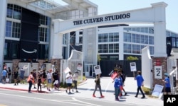 Picketers carry signs outside Amazon Studios in Culver City, California, July 17, 2023.