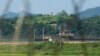 FILE - A North Korean military guard post, upper middle, and South Korean post, bottom, are seen from Paju, South Korea, near the border with North Korea, on Sept. 8, 2023.