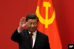 FILE - Chinese President Xi Jinping waves at an event to introduce new members of the Politburo Standing Committee at the Great Hall of the People in Beijing on Oct. 23, 2022.