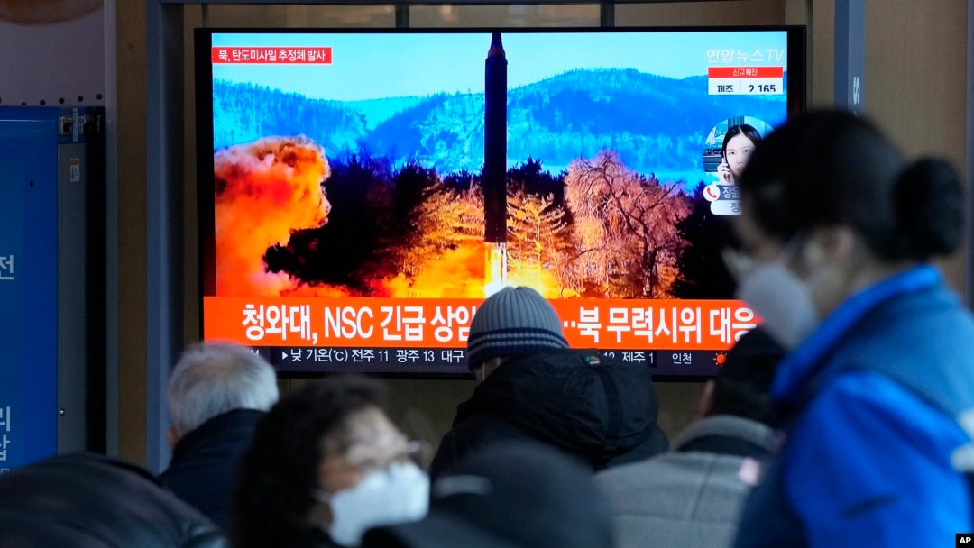 People watch a TV showing a file image of North Korea's missile launch during a news program at the Seoul Railway Station in Seoul, South Korea, Feb. 27, 2022. 