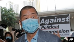 Jimmy Lai, among various of groups of pro-democracy activists, arrives at a court in Hong Kong.