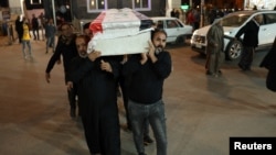 Mourners carry the coffin of a policeman killed in an attack in Kirkuk, during his funeral in Najaf, Iraq, Dec. 18, 2022.