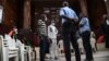 Sidi Mohamed Kounta et Hantao Ag Mohamed Cisse, deux des quatre accusés de l'attaque de Grand Bassam, se tiennent debout après avoir été condamnés à la prison à vie, le 28 décembre 2022. AFP / Sia Kambou

