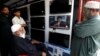 Shopkeepers watch the speech of Pakistani Prime Minister Imran Khan, after Pakistan shot down two Indian military aircrafts, at a shop selling television screens in Karachi, Pakistan, Feb. 27, 2019.