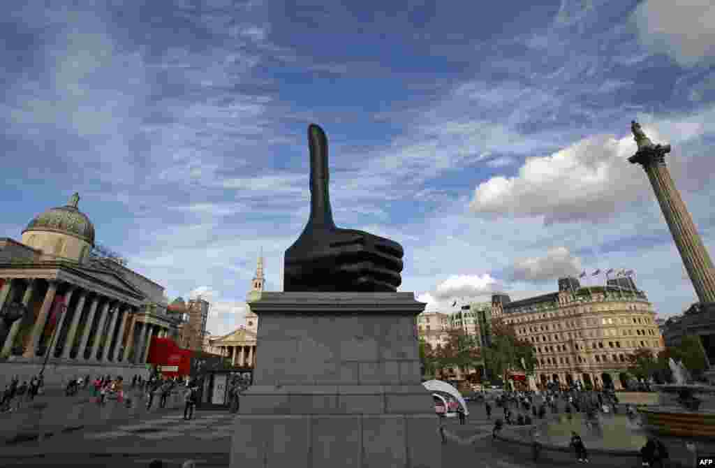 The new Fourth Plinth sculpture, "Really Good" by British artist David Shrigley, is pictured in Trafalgar Square in central London. Shrigley is best known for his distinctive drawing style and works that make satirical comments on everyday situations and human interactions. "Really Good" is a seven-meter-high hand with a disproportionately long thumb giving a thumbs up.