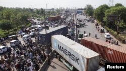 Vehicles are parked to block the roads, ahead of a planned protest march towards Islamabad led by ousted Prime Minister Imran Khan, in Lahore, Pakistan, May 24, 2022.