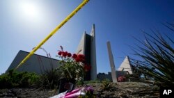 Flowers sit outside crime scene tape at Geneva Presbyterian Church on May 17, 2022, in Laguna Woods, Calif. A shooting at the church on May 15, 2022, left one dead and five injured. AP Photo.