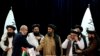 Mullah Abdul Ghani Baradar, Acting Deputy Prime Minister of the Afghan Taliban's caretaker government, center, and the chief financial officer of GAAC Solutions, Razack Aslam Mohammed Abdur Razack, shake hands after signing documents in Kabul, Afghanistan, May 24, 2022.